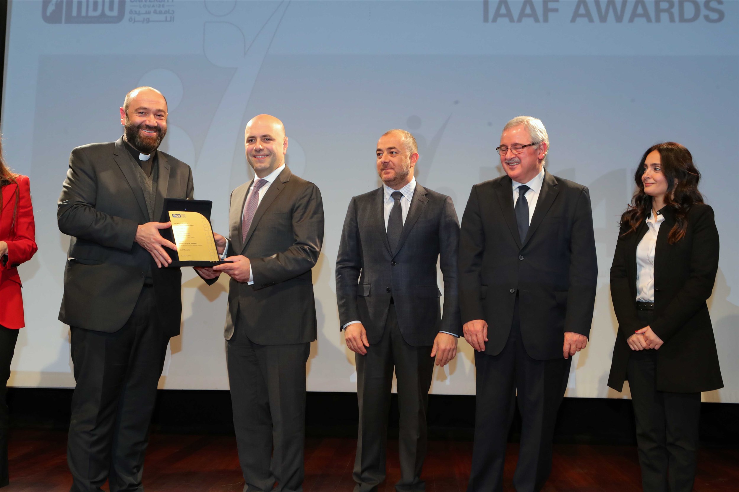 minister of public health his excellency ghassan hasbani receives a sheild of appreciation from the notre dame university- louaize for his accomplishments.