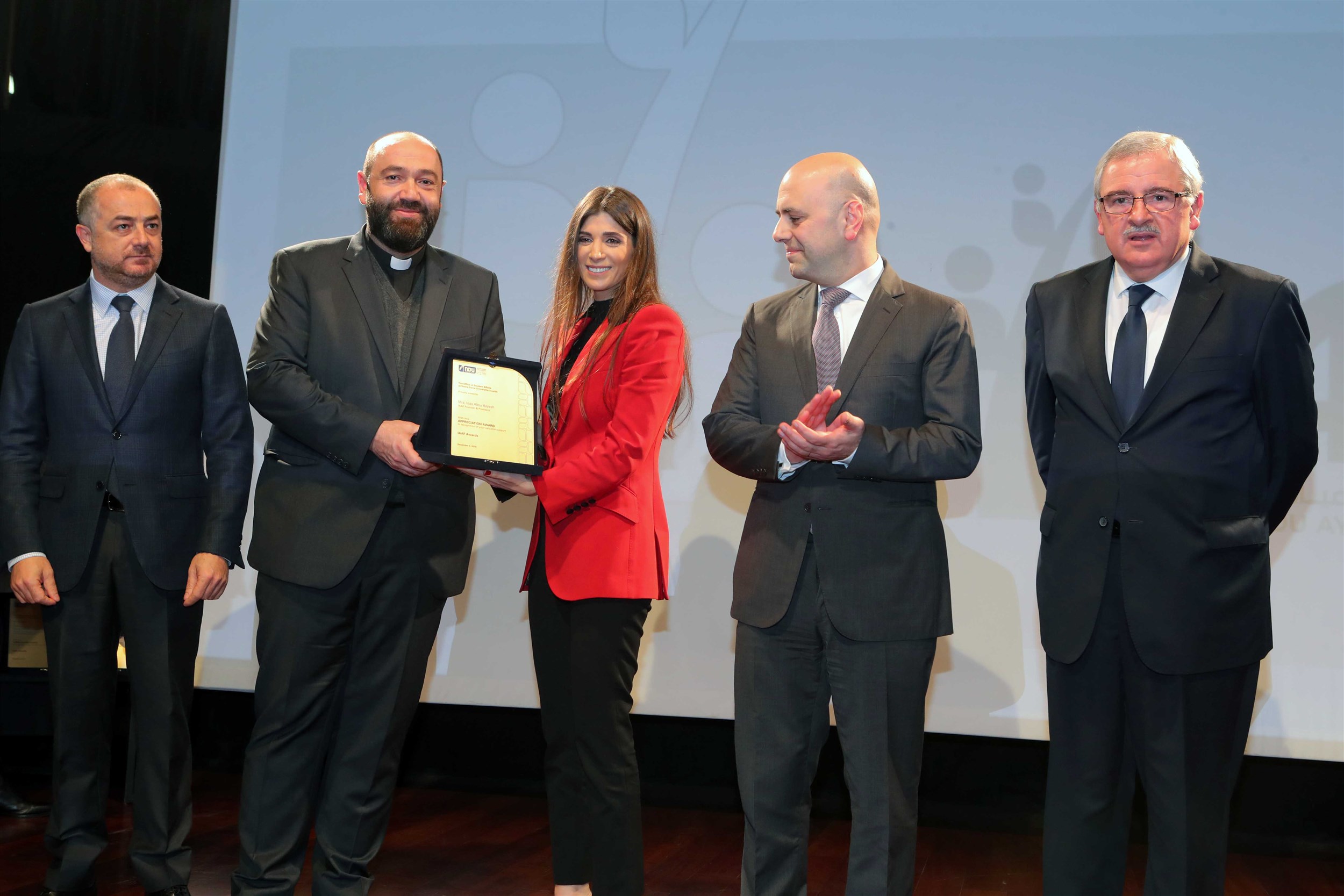 founder and president of the iaaf mrs. inas al jarmakani receives a sheild of appreciation from the notre dame university- louaize for her contribution to the lebanese youth.