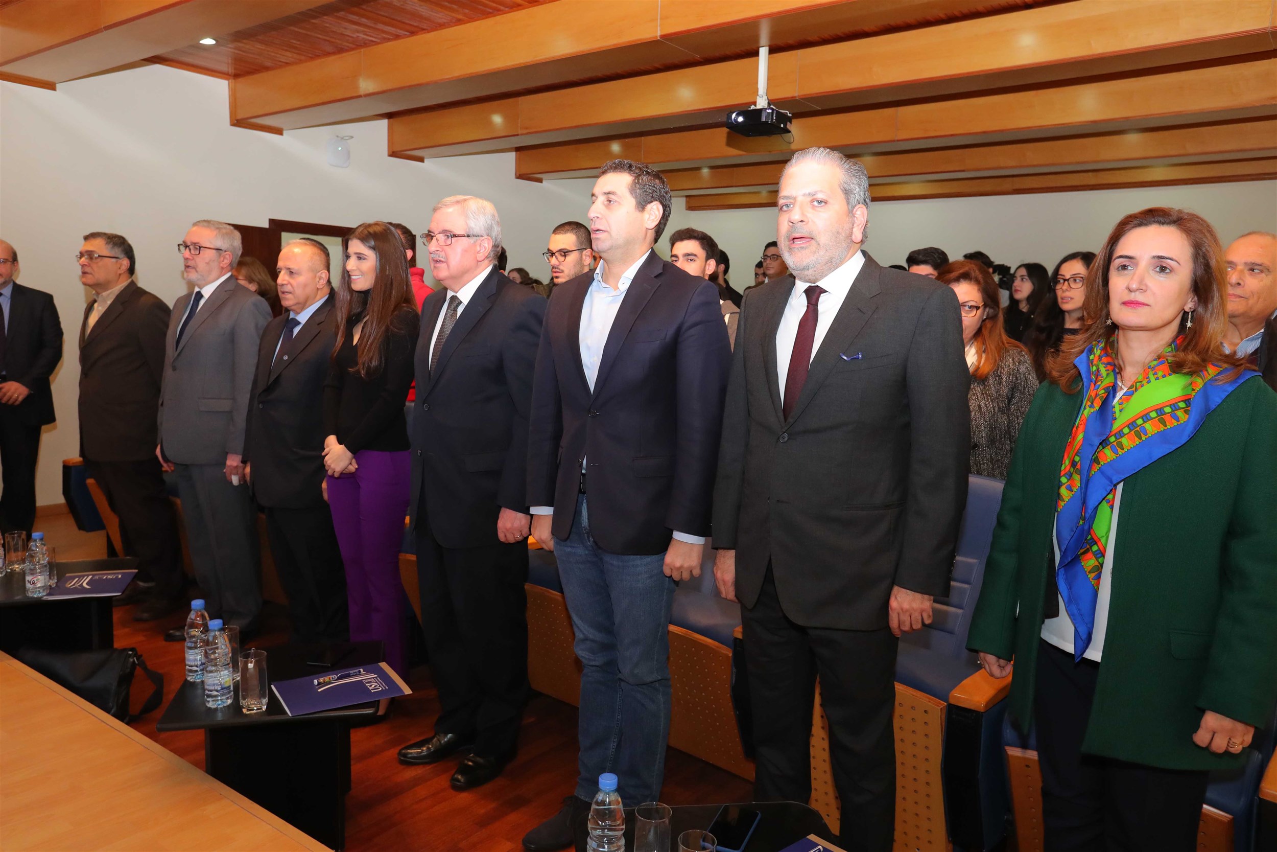 president professor salim daccach, president of the iaaf mrs. inas al jarmakani, minister of state for women affairs mr. jean oghassapian, member  of  the  parliament mr. eddy  maalouf, mr. maroun chammas, professor may sayegh and professor joseph mezher rise for the lebanese national anthem.